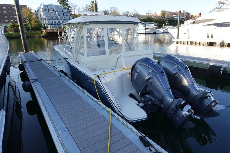 Slide: The Image of 2021 Grady-White Freedom 325 boat docked with dual outboard engines. - 5