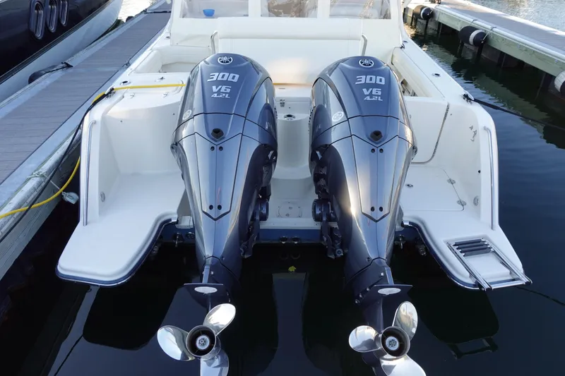 Slide: The Image of 2021 Grady-White Freedom 325 boat with twin 300 V6 outboard engines at dock. - 6