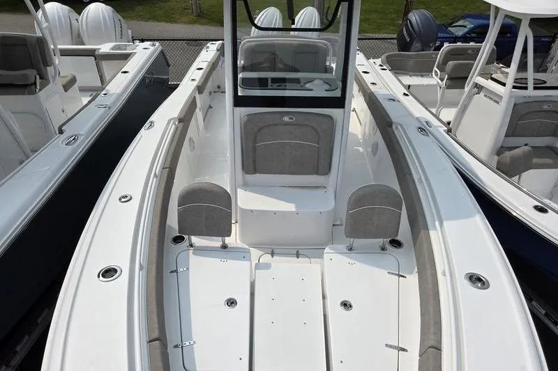 Slide: The Image of 2025 Sea Hunt Ultra 275 SE boat interior with seating and console. - 13