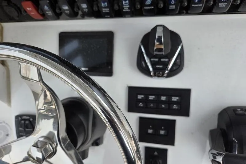 Slide: The Image of 2025 Sea Hunt Ultra 275 SE dashboard with steering wheel and control panel. - 14
