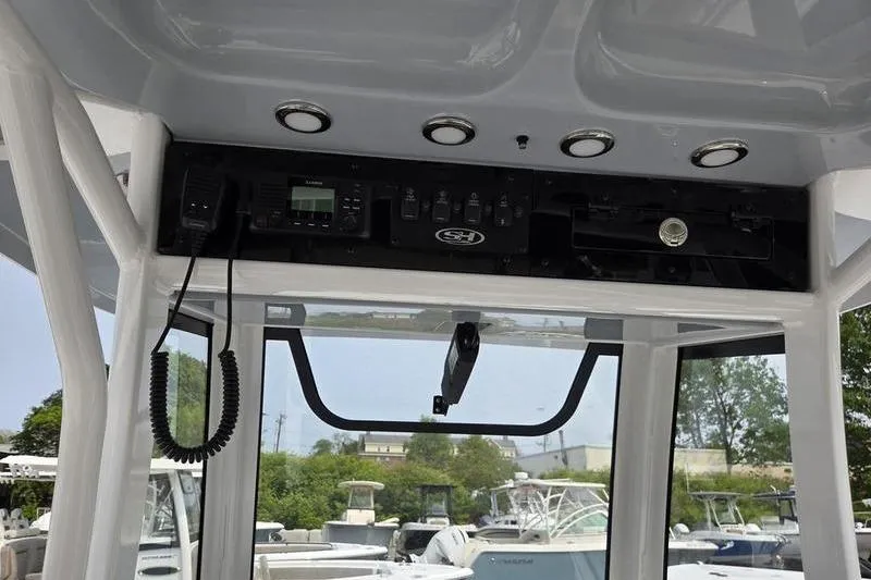 Slide: The Image of Interior view of 2025 Sea Hunt Ultra 275 SE boat's control panel and electronics. - 16