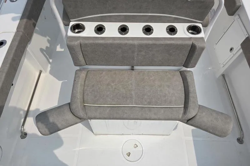 Slide: The Image of 2025 Sea Hunt Ultra 275 SE boat seating with cup holders, gray upholstery, and armrests. - 3