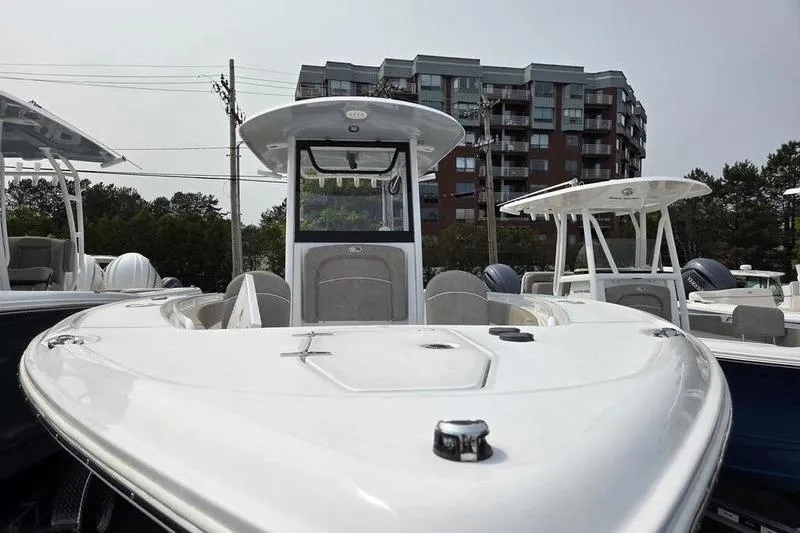 Slide: The Image of 2025 Sea Hunt Ultra 275 SE boat displayed outdoors near buildings. - 8