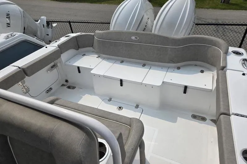 Slide: The Image of 2025 Sea Hunt Ultra 275 SE boat interior with cushioned seating and storage compartments. - 9