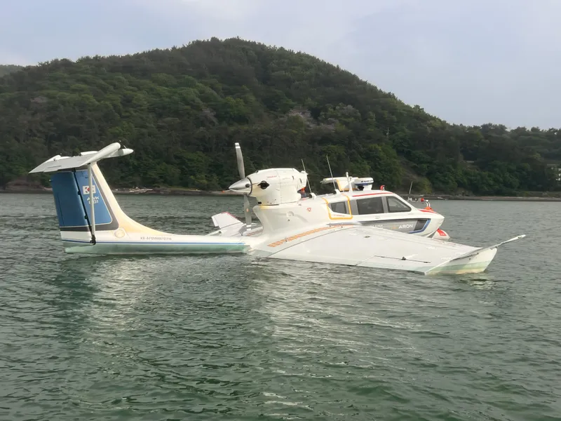 Slide: The Image of Futuristic Aron M 80 seaplane on water, 2025 model, with forested hills in the background. - 18