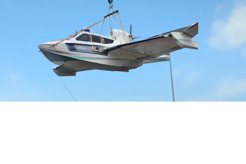 Slide: The Image of Aerial view of Aron M 80 seaplane, 2025 model, suspended by crane against blue sky. - 43
