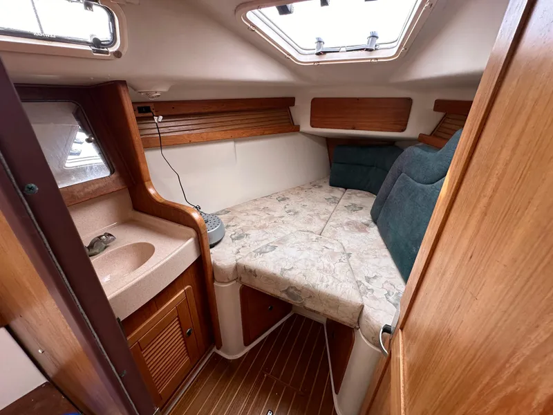 Slide: The Image of Cozy cabin interior of 1998 Catalina 380 sailboat with bed and sink. - 10