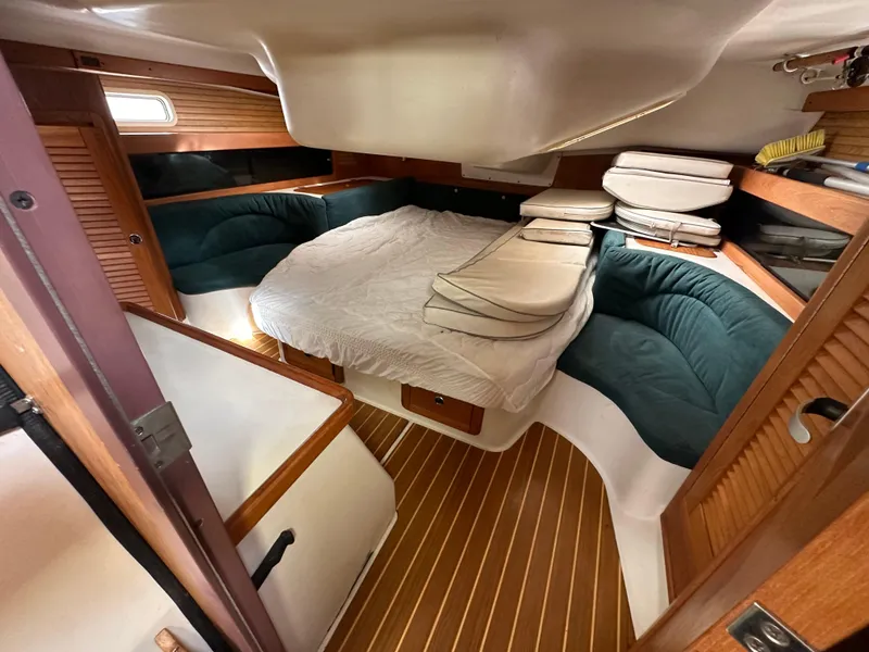 Slide: The Image of Cozy cabin interior of 1998 Catalina 380 sailboat with wood accents and plush seating. - 12