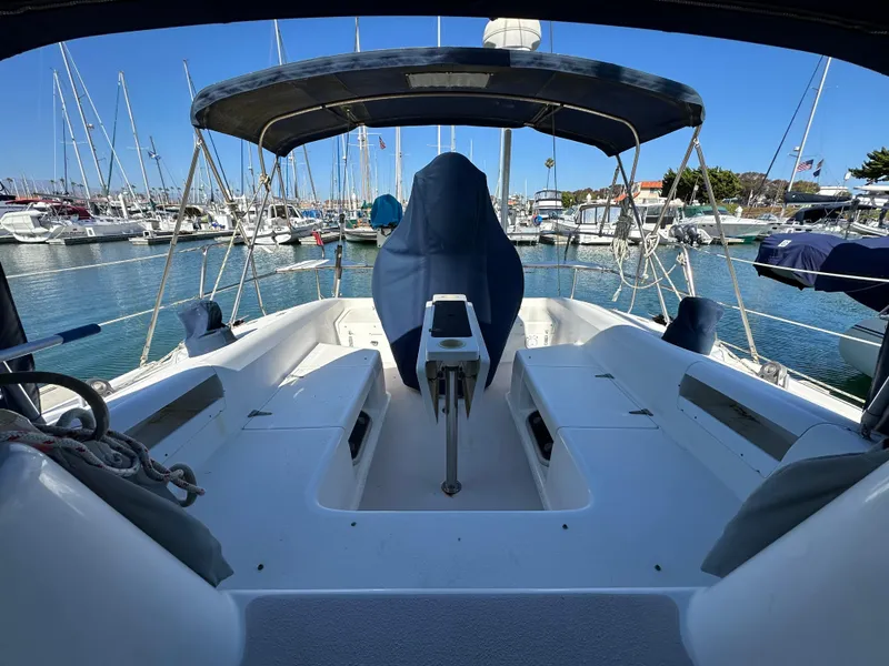 Slide: The Image of 1998 Catalina 380 sailboat cockpit in marina, covered helm, clear blue sky. - 3