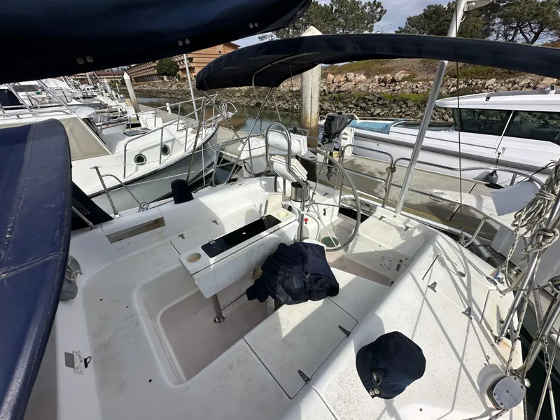 Slide: The Image of 1998 Catalina 380 sailboat cockpit with seating, docked at marina. - 5