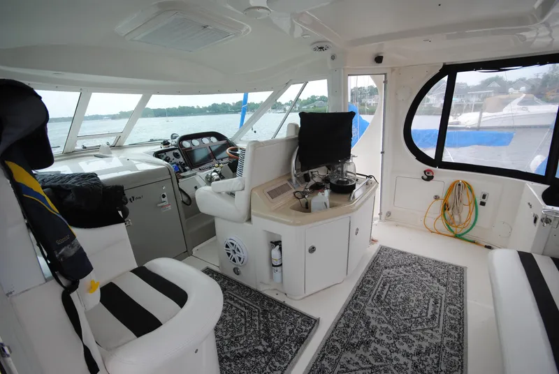 Slide: The Image of Interior of 2005 Sea Ray 390 Motor Yacht with helm and seating area. - 10