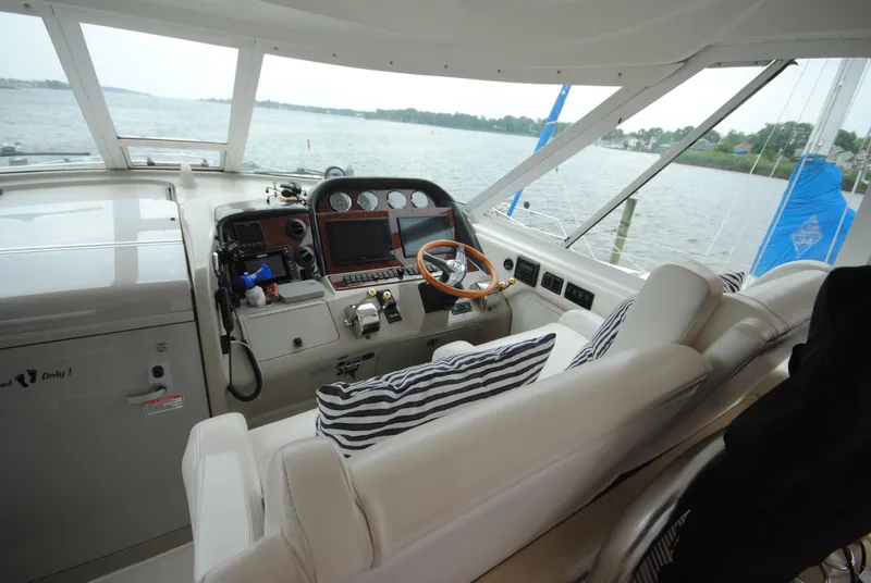 Slide: The Image of 2005 Sea Ray 390 Motor Yacht helm with leather seating and panoramic water view. - 13