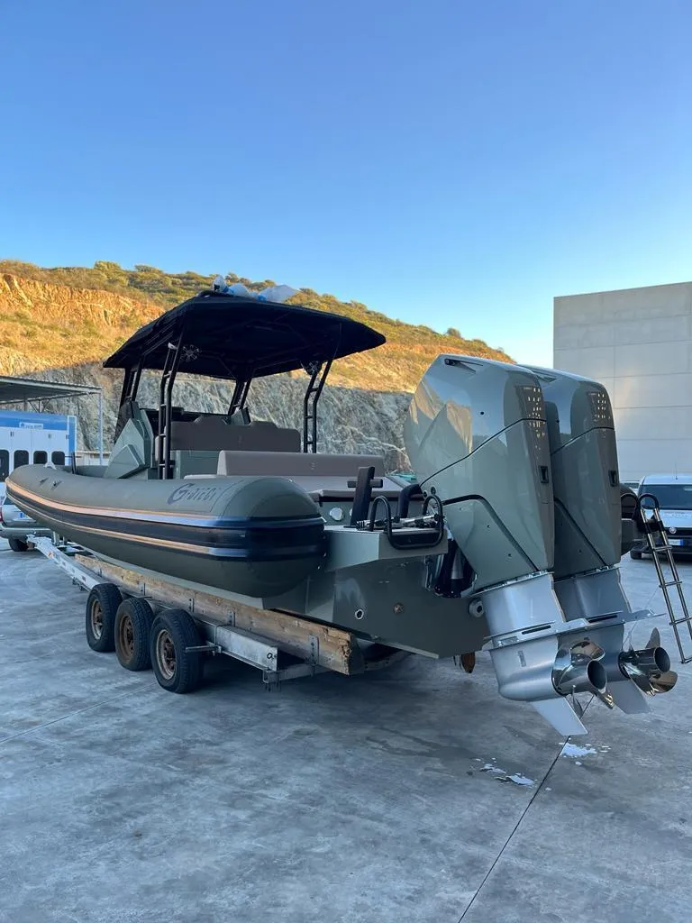 Slide: The Image of 2024 G-Tender DIECI boat with dual engines on a trailer, outdoor setting. - 12