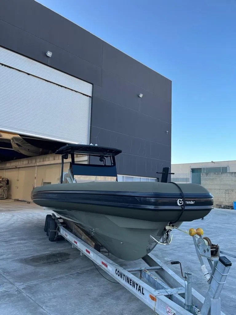 Slide: The Image of 2024 G-Tender DIECI boat on trailer outside industrial building. - 13