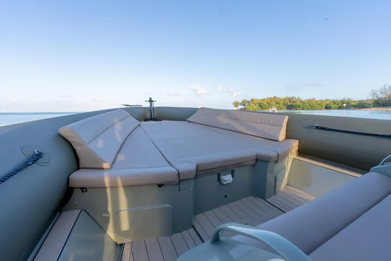 Slide: The Image of 2024 G-Tender DIECI boat interior with cushioned seating and scenic water view. - 2