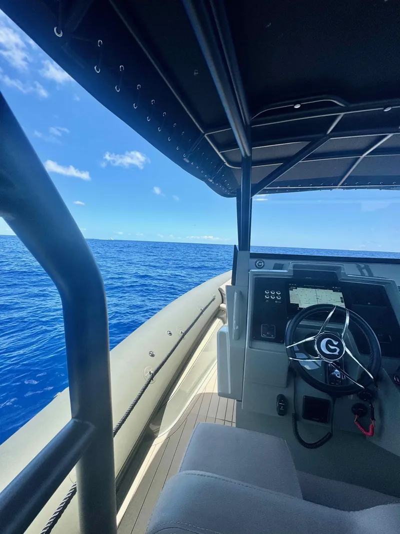 Slide: The Image of 2024 G-Tender DIECI boat steering console with ocean view under clear blue sky. - 32