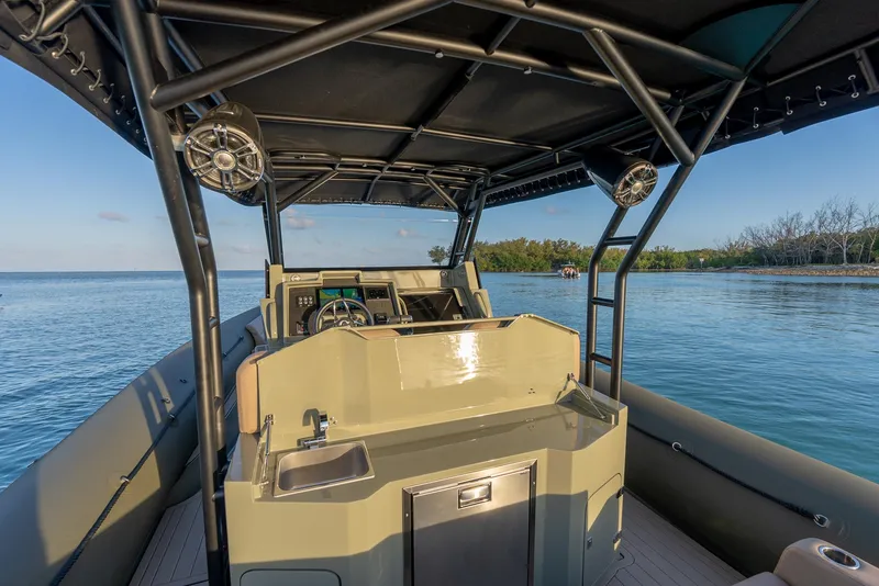 Slide: The Image of 2024 G-Tender DIECI boat interior with steering console, sink, and canopy on calm water. - 33