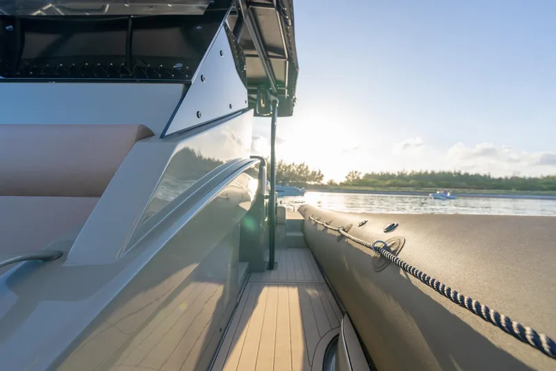 Slide: The Image of 2024 G-Tender DIECI boat on water at sunset, sleek design, side view. - 38