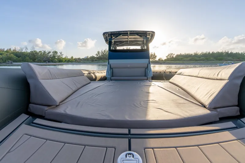 Slide: The Image of 2024 G-Tender DIECI boat with spacious sunbathing area, set against a serene water backdrop. - 44