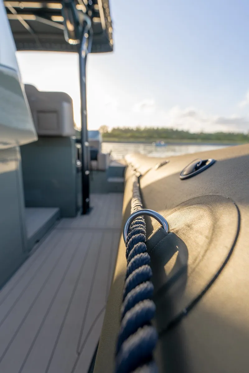 Slide: The Image of 2024 G-Tender DIECI boat deck with rope detail, sunny day, calm waters. - 48