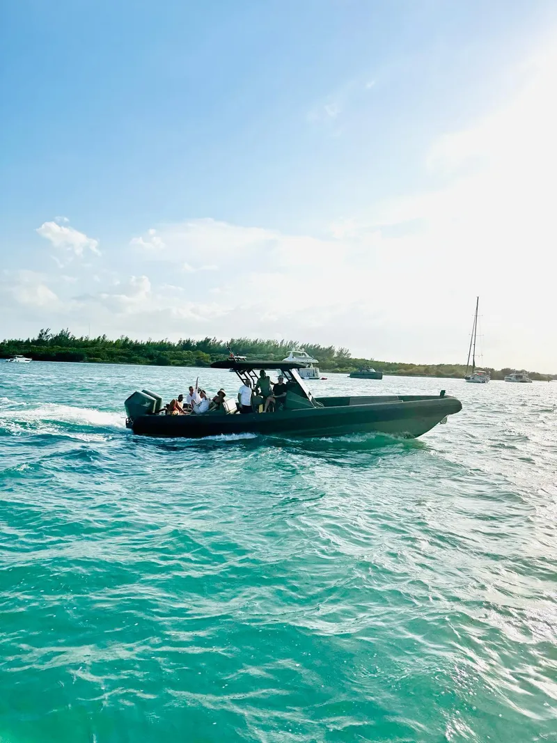 Slide: The Image of 2024 G-Tender DIECI boat cruising on turquoise waters under a clear blue sky. - 6