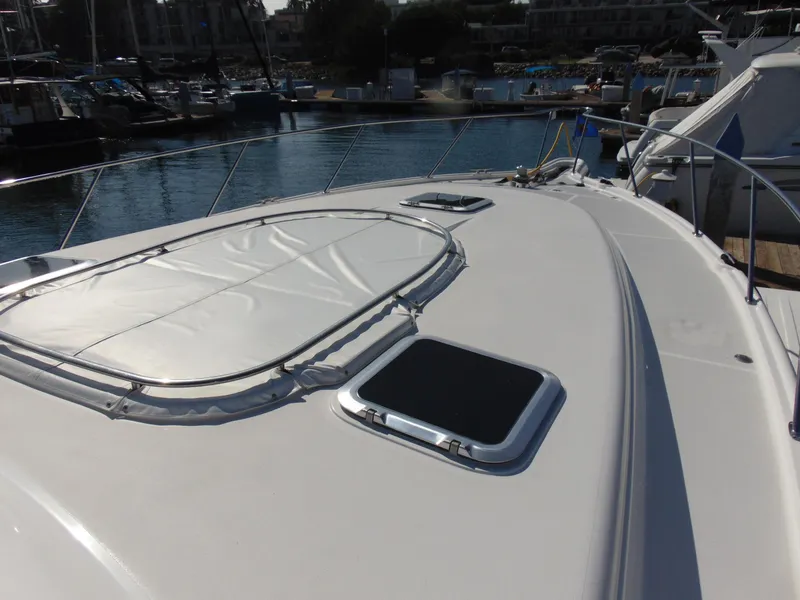 Slide: The Image of 2000 Tiara Yachts 5000 Express yacht deck with hatches, docked in marina. - 15