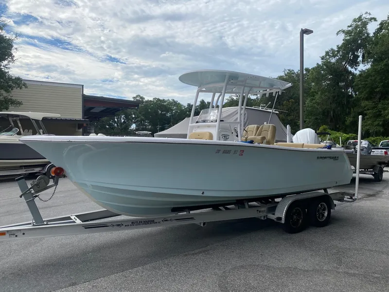 Slide: The Image of 2022 Sportsman Heritage 231 boat on trailer, parked outdoors under cloudy sky. - 3