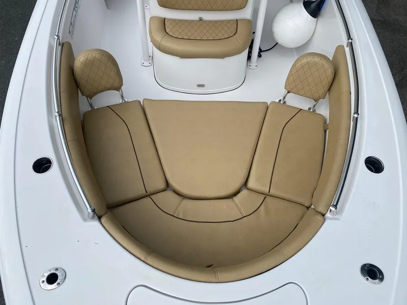 Slide: The Image of 2022 Sportsman Heritage 231 boat with tan cushioned seating in the bow area. - 5