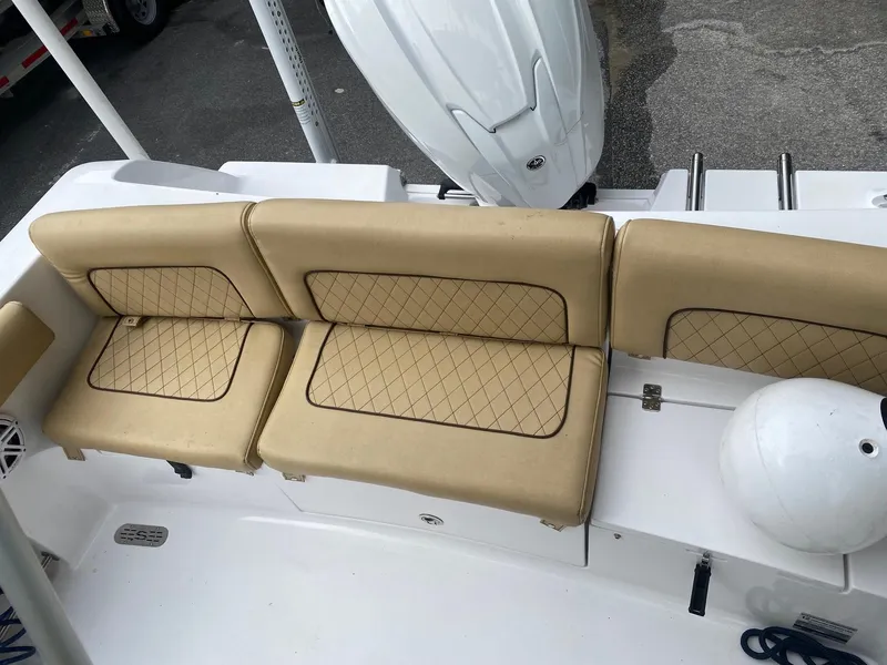 Slide: The Image of 2022 Sportsman Heritage 231 boat with tan cushioned seating and white motor. - 6