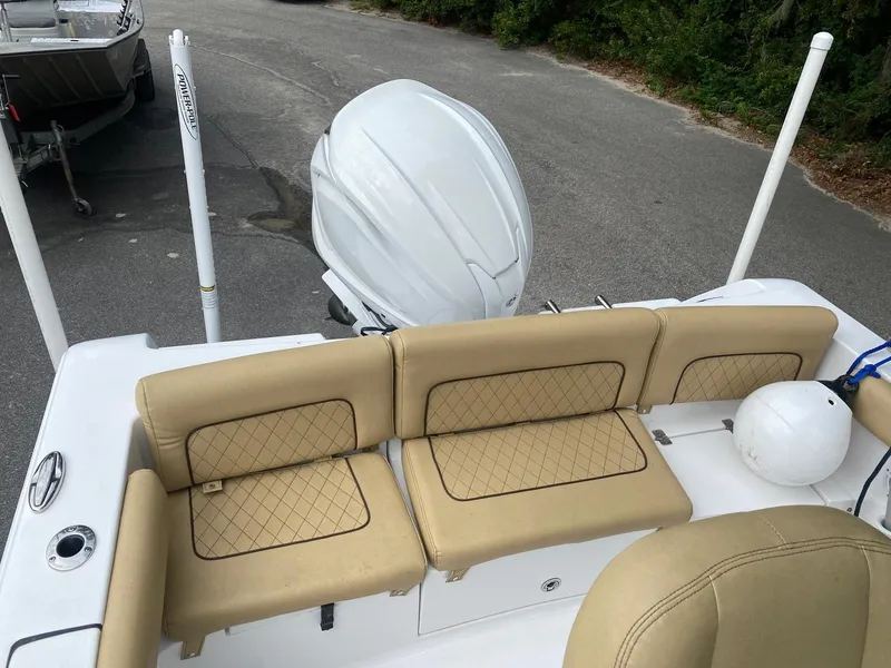 Slide: The Image of 2022 Sportsman Heritage 231 boat with tan seating and white outboard motor. - 8
