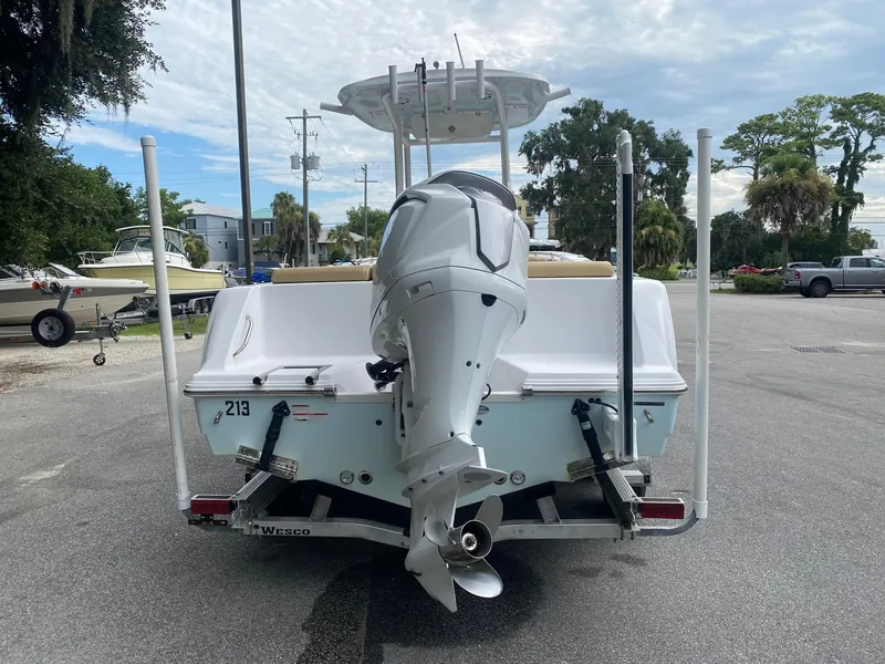 Slide: The Image of 2022 Sportsman Heritage 231 boat with outboard motor, parked on a trailer. - 9