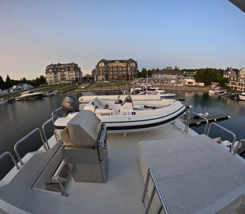Slide: The Image of Hargrave 93' yacht deck view with tender and marina backdrop, 2007 model. - 11