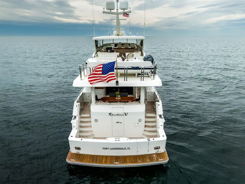 Slide: The Image of Luxury Hargrave yacht, 93-foot model from 2007, cruising in open sea with American flag. - 3
