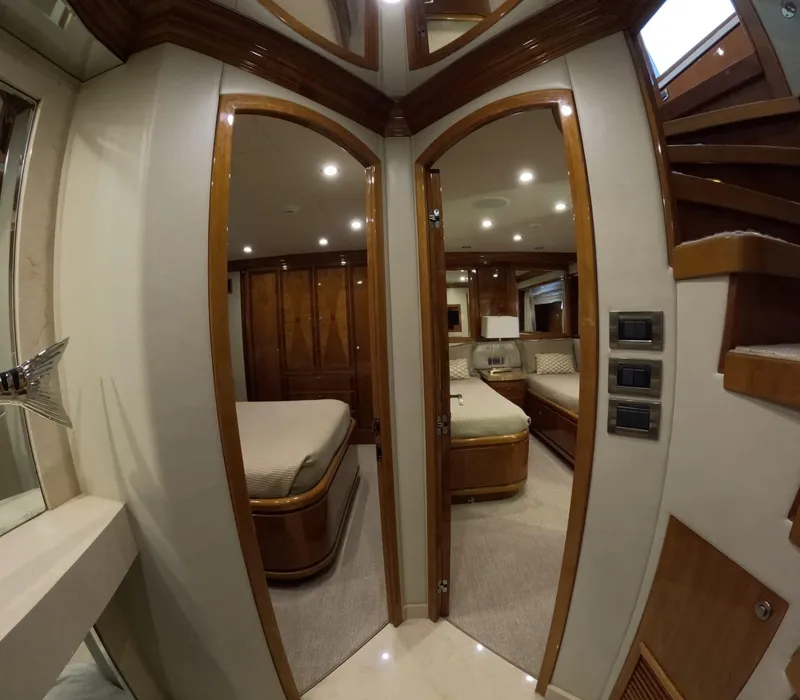 Slide: The Image of Interior of 2007 Hargrave 93' yacht showing luxurious bedrooms and wooden finishes. - 31