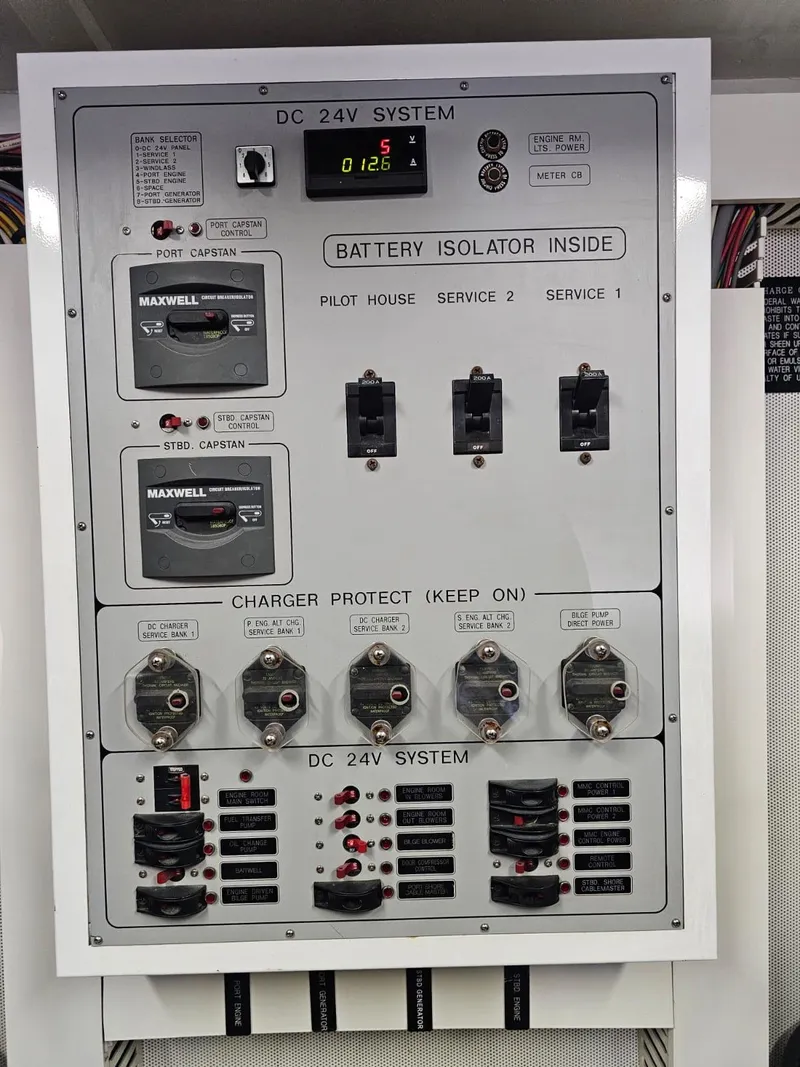 Slide: The Image of Electrical panel of 2007 Hargrave 93' yacht, featuring DC 24V system and battery isolator. - 43