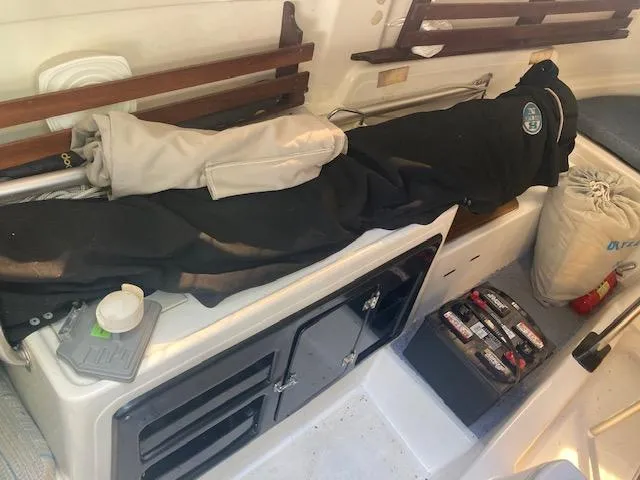 Slide: The Image of Interior of a 1997 MacGregor 26 X sailboat with storage and equipment. - 11