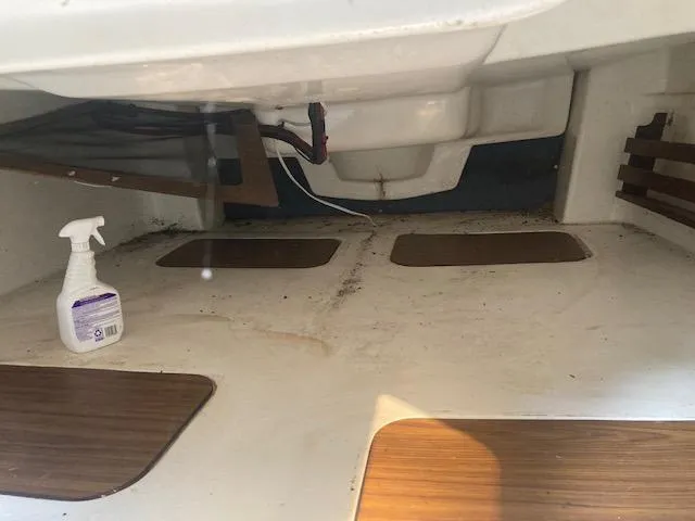 Slide: The Image of Interior of a 1997 MacGregor 26 X boat with cleaning spray bottle. - 12