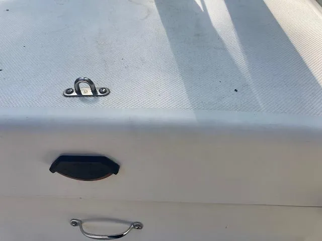 Slide: The Image of Close-up of a 1997 MacGregor 26 X boat deck with metal fittings. - 14