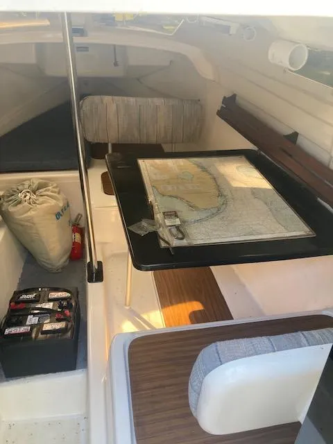 Slide: The Image of Interior of a 1997 MacGregor 26 X sailboat with navigation chart and equipment. - 9