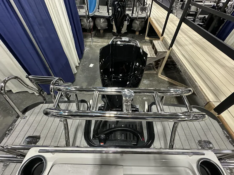 Slide: The Image of 2024 Starcraft EXS 3 HB4TT boat with sleek chrome railings and powerful outboard motor. - 19