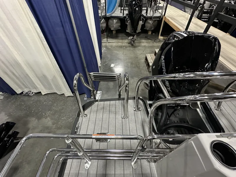 Slide: The Image of 2024 Starcraft EXS 3 HB4TT boat with Mercury engine, featuring sleek chrome railings. - 20