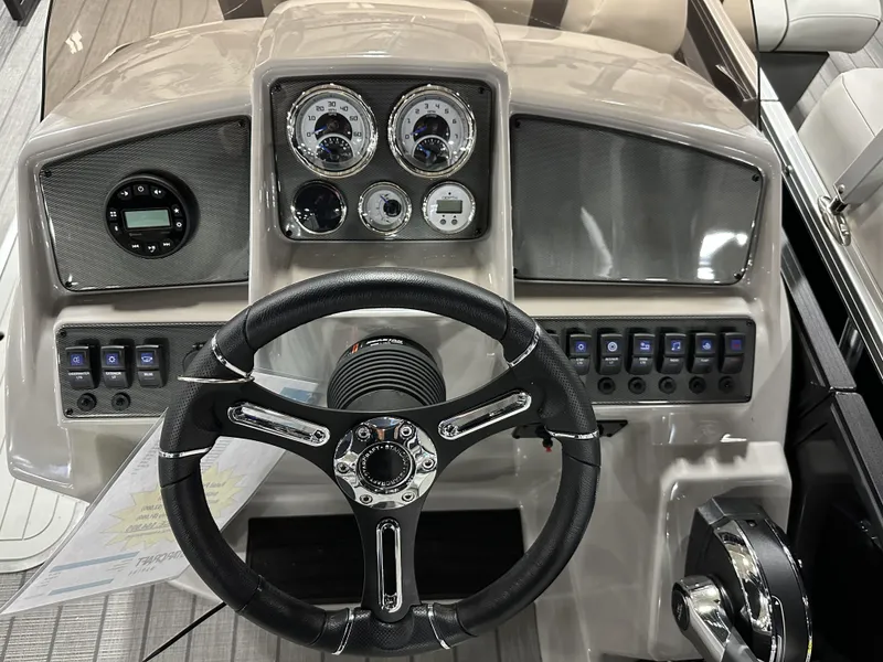 Slide: The Image of 2024 Starcraft EXS 3 HB4TT boat dashboard with steering wheel and control panel. - 7