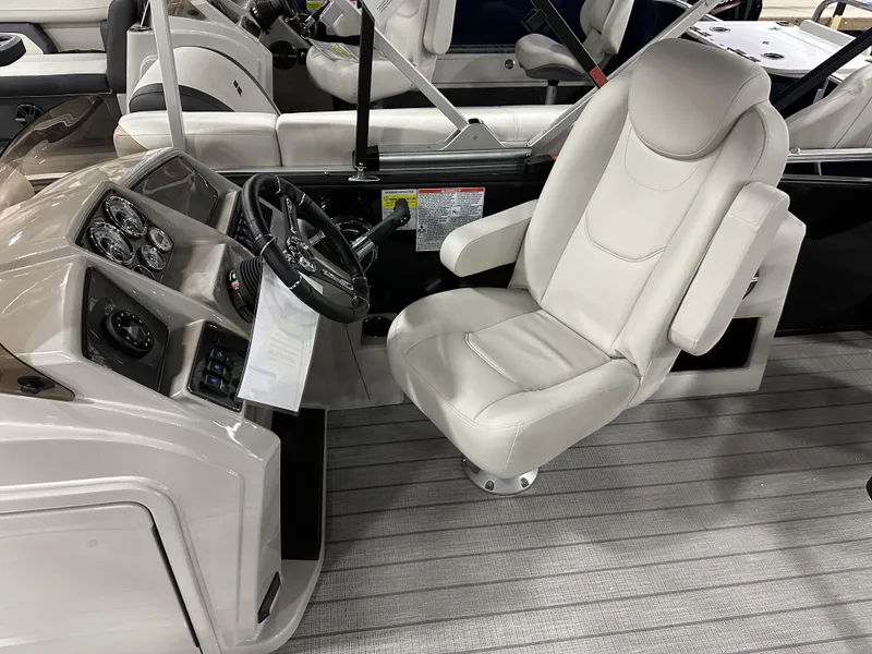 Slide: The Image of 2024 Starcraft EXS 3 HB4TT boat interior with steering console and plush captain's chair. - 8