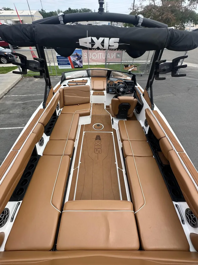 Slide: The Image of 2023 Axis T250 boat interior with tan seating and modern dashboard. - 10
