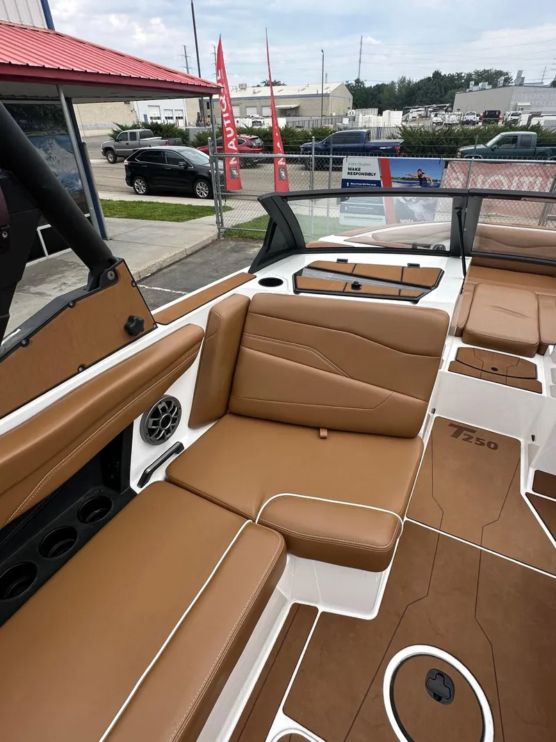 Slide: The Image of 2023 Axis T250 boat interior with brown seating and modern design. - 14