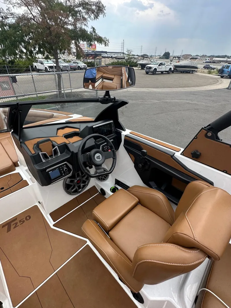 Slide: The Image of 2023 Axis T250 boat interior with tan leather seats and modern dashboard. - 15