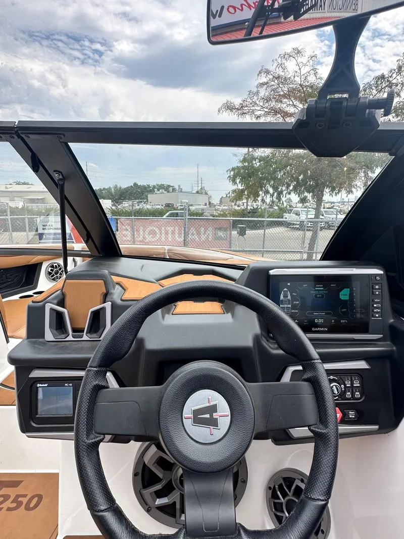 Slide: The Image of 2023 Axis T250 boat dashboard with steering wheel and digital display. - 16