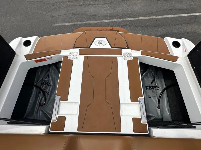 Slide: The Image of 2023 Axis T250 boat deck with brown and white design, featuring storage compartments. - 19
