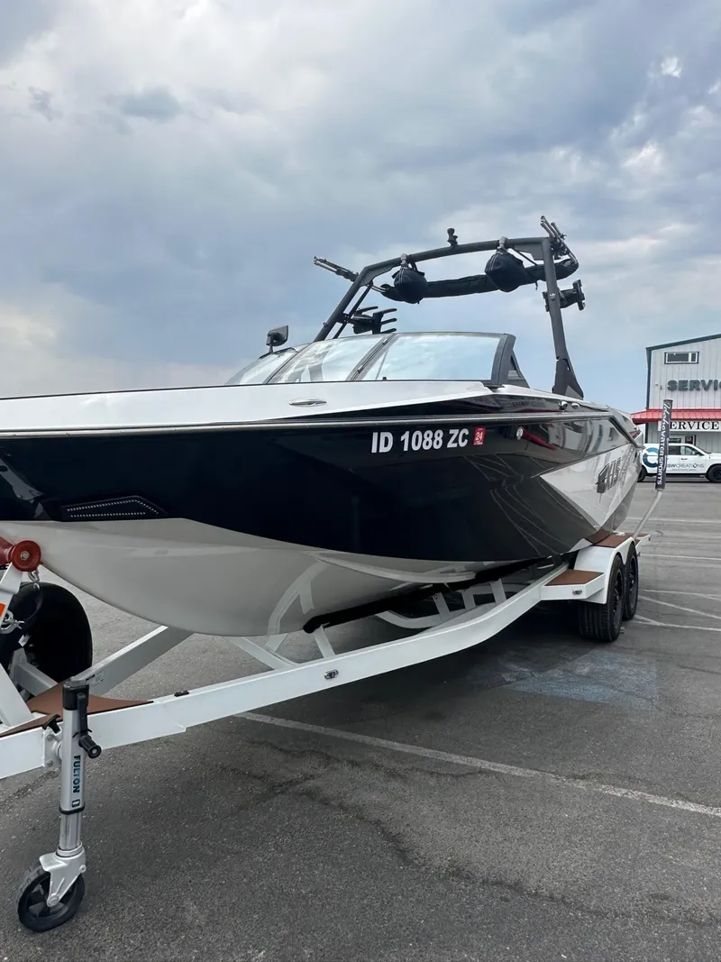 Slide: The Image of 2023 Axis T250 boat on trailer under cloudy sky. - 5