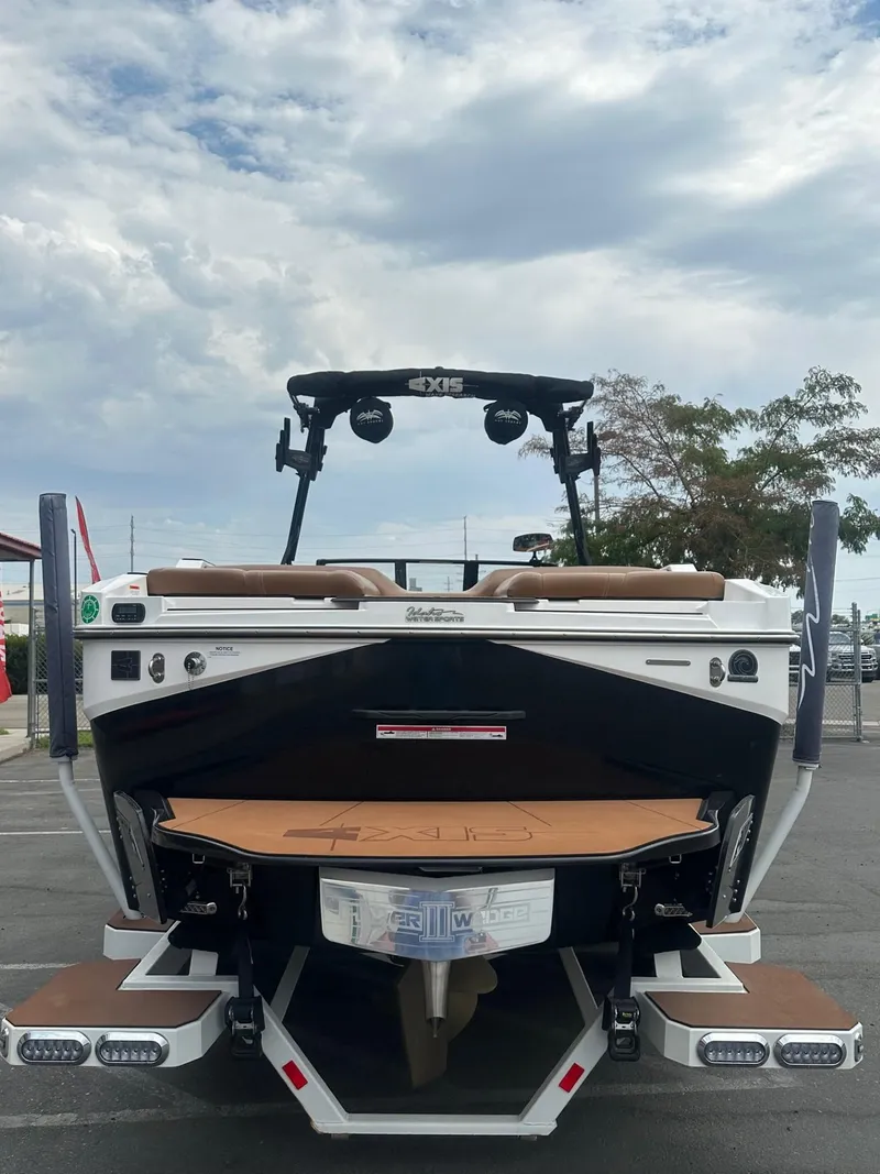Slide: The Image of 2023 Axis T250 boat rear view with wakeboard tower and swim platform. - 8